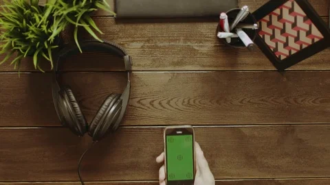 Top down view of man using smartphone with green screen and putting on Stock Footage 81184891