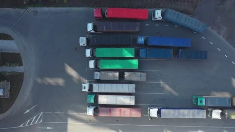 Top-down view of many trucks with trailers full of grain waiting to unload goods Stock Footage 155490513
