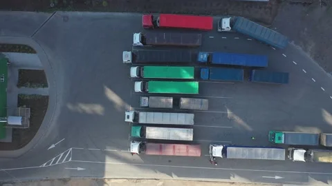 Top-down view of many trucks with trailers full of grain waiting to unload goods Stock Footage 155490624