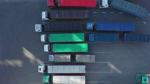 Top-down view of many trucks with trailers full of grain waiting to unload goods Stock Footage 155490764