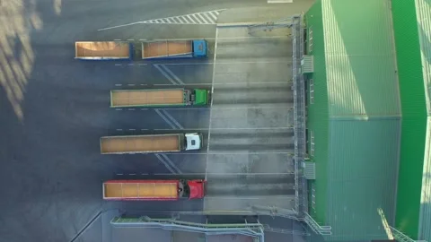 Top down view of many trucks with trailers full of grain waiting to unload goods Stock Footage 155801331