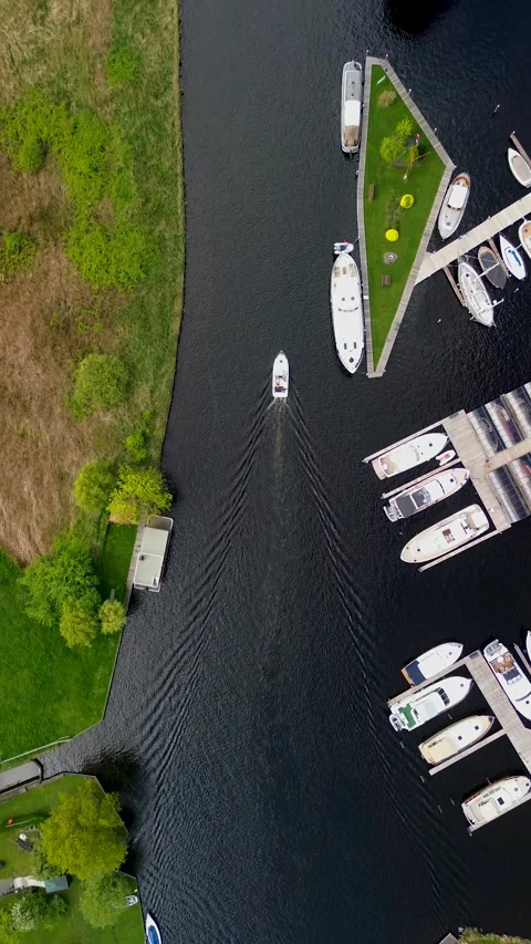 A top-down view of a marina with multiple boats docked along wooden piers Stock Footage 310562083