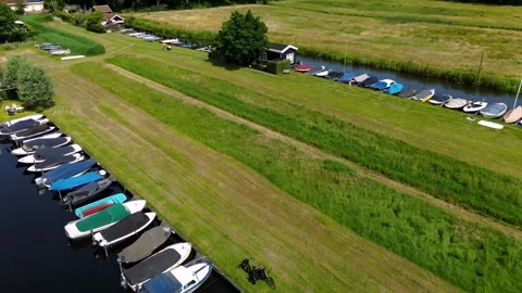 A top-down view of a marina with multiple boats docked along wooden piers Stock Footage 313295244