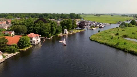 A top-down view of a marina with multiple boats docked along wooden piers Stock-Footage 313358455