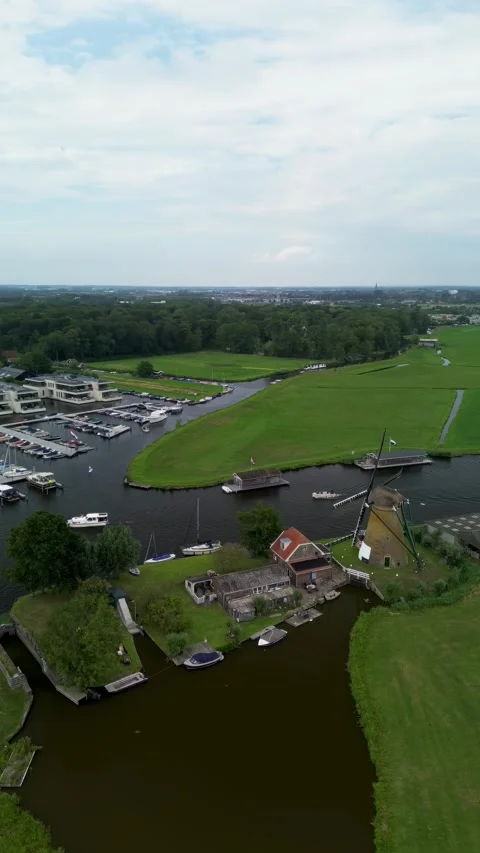 A top-down view of a marina with multiple boats docked along wooden piers Stock Footage 314058815