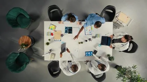 Top down view of medical experts group review clinical data Stock Photos