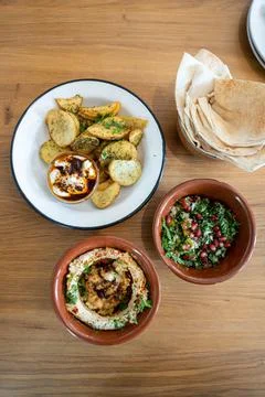 Top down view of a mezze table with za'atar fries, hummus, tabbouleh 스톡 사진