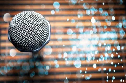 Top-Down View of a Microphone Head on a Striped Yellow and Black Bamboo Mat Stock Photos