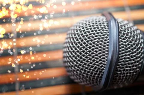Top-Down View of a Microphone Head on a Striped Yellow and Black Bamboo Mat Stock Photos