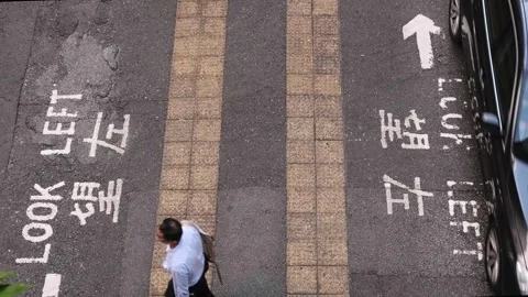 Top down view on middle of crosswalk, with pedestrians and cars. Stock Footage 251966996