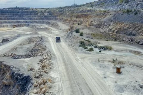 Top-down view of mining trucks driving along the road inside an Stock Photos