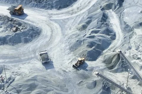 Top-down view of mining trucks driving along the road inside an Stock Photos