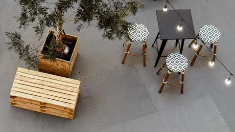 Top down view of modern restaurant patio with a cozy table setup. Stock Photos
