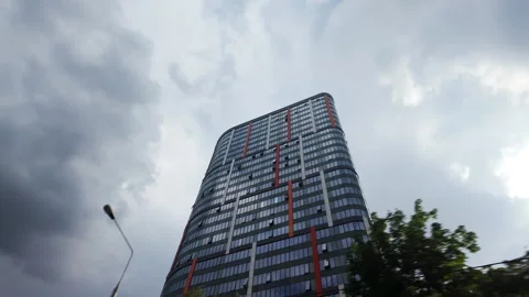 Top down view of a modern tall glass residential building in the city against a Stock Footage 278372365