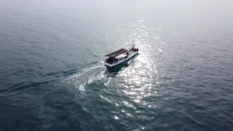 Top Down View Of  Motor Boat Racing On The Water with Sun Reflection Stock Footage 245563679