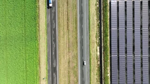 Top down view of motorway with vehicles driving along solar panels. Stock Footage 249518376