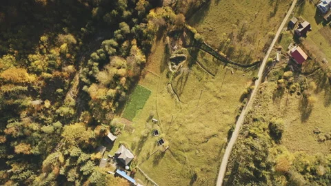 Top down view mountain village. Isolated farm in autumn pine tree forest. Eco Stock Footage 155608587
