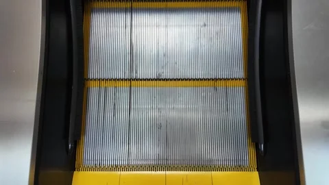 Top Down View of Moving Escalator with Yellow Safety Stripes Vídeo Stock 330479709