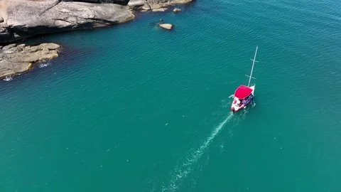 Top down view of a moving sailboat off the coast of an island. Stock Footage 266501040