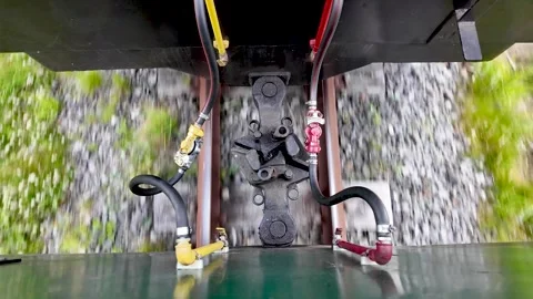 Top Down View of Moving Train Couplers and Air Hoses on Railway Track 库存影片 339377974