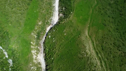 Top down view of narrow dried riverbed and green hills in Kazakhstan Stock-Footage 337183373