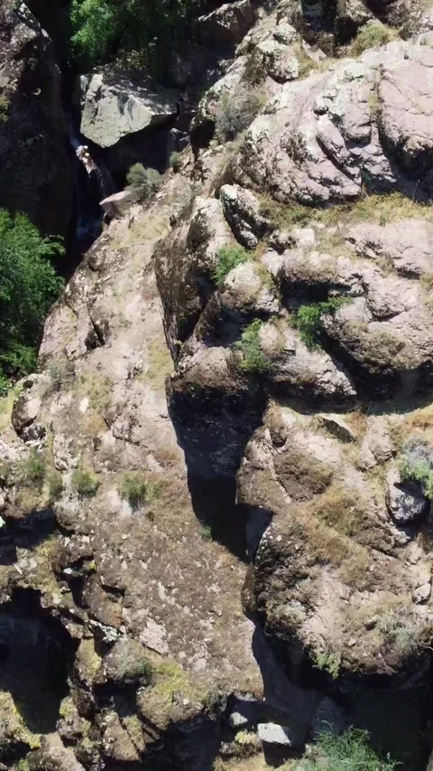Top down view of narrow rocky gorge and wild stream bed in Kazakhstan Видео 338123702