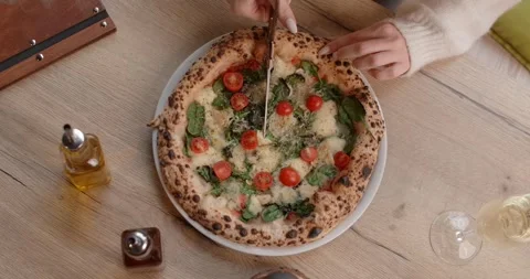 Top down view of the Neapolitan pizza cutting by the scissors Stock Footage 282966133
