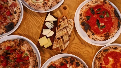 Top Down View of Neapolitan Pizzas and Italian Antipasto Platter 스톡 동영상 339422526