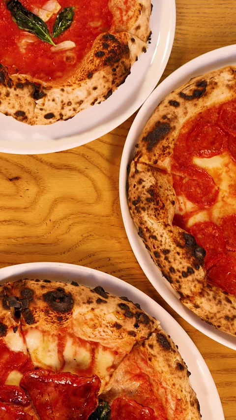 Top Down View of Neapolitan Pizzas on a Restaurant Table Stock Footage 339752135
