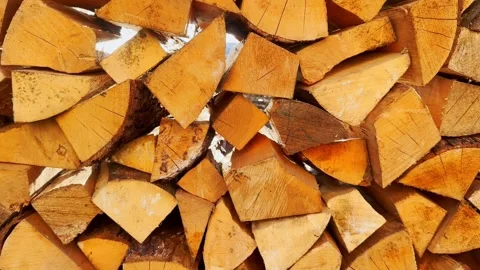 Top-down view of neatly stacked split firewood, showing golden cut log ends Stock Footage 336709616