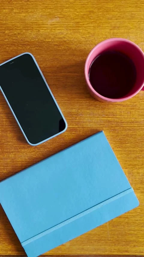 Top down view of notebook coffee and smartphone on table Video stock 331772754
