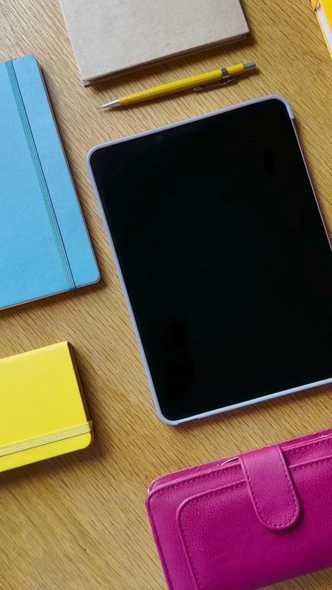 Top down view of notebooks tablet and pink wallet Video stock 331772603