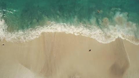 Top down view ocean beach waves break white sand Stock Photos