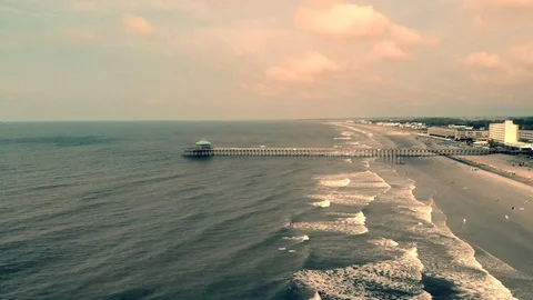 Top Down View of Ocean Pier and People Playing on the beach Stock Footage 94632366