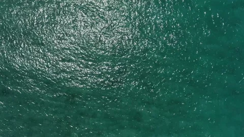 Top-down view of the ocean surface. Turquoise clear water and sun glare. Stock Footage 160440910