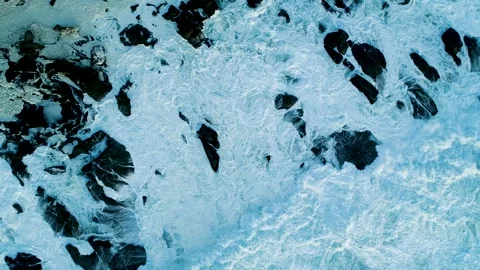 Top down view of ocean swells rolling towards the coastline The Concept of .. Stock Footage 336544315