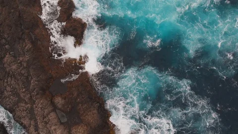 Top-down view of the ocean washing the large beautiful rocks on the Atlantic Видео 112095289