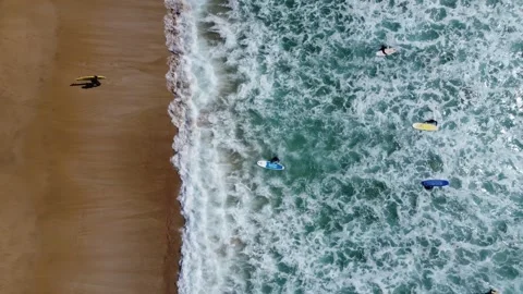 Top down view of ocean waves and surfers, fuerteventura, spain Video stock 286721436