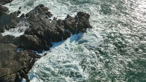 Top Down View of Ocean Waves and Sea Foam Pattern Stock Footage 340123842