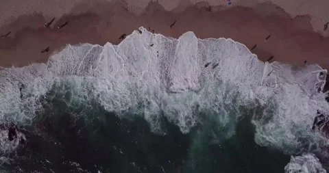 Top-Down View of Ocean Waves Rolling onto a Sandy Seashore Stock Footage 340962291