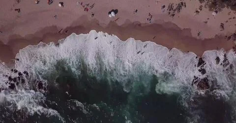 Top-Down View of Ocean Waves Rolling onto a Sandy Seashore Stock Photos