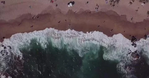 Top-Down View of Ocean Waves Rolling onto a Sandy Seashore Stock Photos