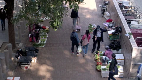 Top down view, officer telling road-side vegetable stand to stop business 스톡 동영상 252774860