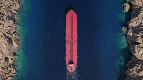 Top down view of oil tanker crossing narrow rocky strait Stock Footage 340332106