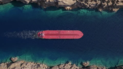 Top down view of oil tanker moving across narrow rocky strait Stock Footage 340332123