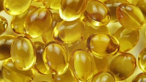 Top down view omega 3 gold fish oil capsules, rotation background, macro Stock-Footage 155139237