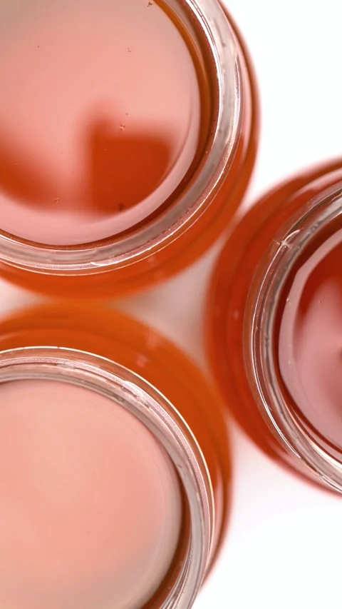 Top-down view of open glass jars filled with pure golden amber honey Stock-Footage 342299951