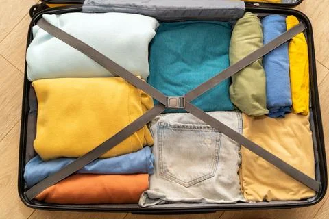 Top down view of an open suitcase prepared for travel. Stock Photos