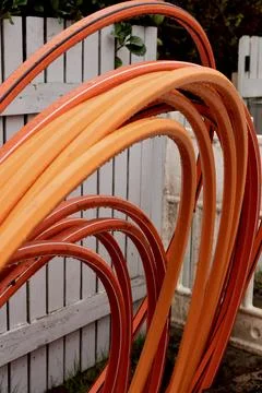 Top-down view of orange and grey cables behind a construction barrier. Stock Photos