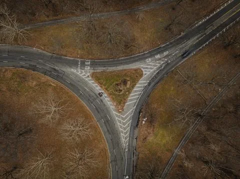 Top down view over an intersection, in a triangular shape, on a cloudy day in au 스톡 사진